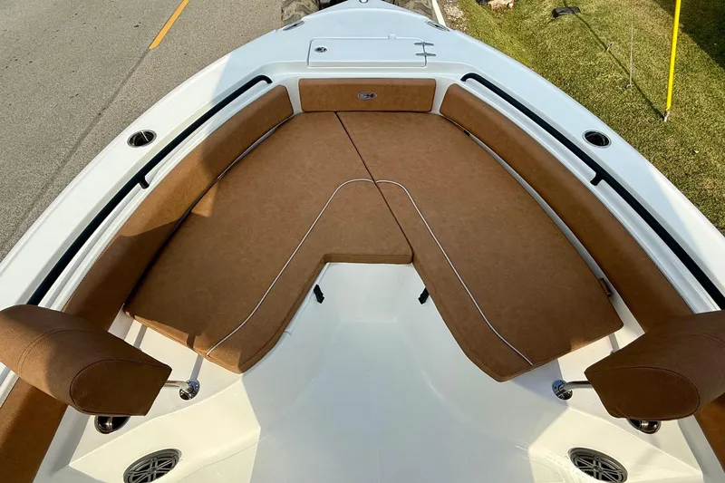 Slide: The Image of 2026 Sea Hunt Ultra 235 SE boat with brown cushioned seating and white deck. - 14