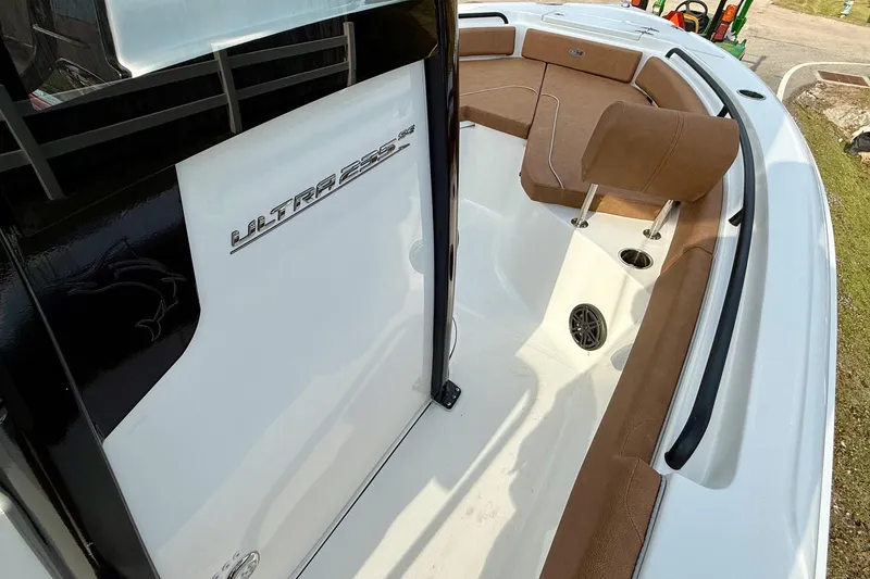 Slide: The Image of 2026 Sea Hunt Ultra 235 SE boat interior with brown seating and sleek design. - 15