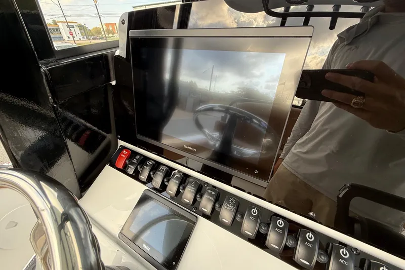 Slide: The Image of Control panel of 2026 Sea Hunt Ultra 235 SE boat with Garmin display. - 17