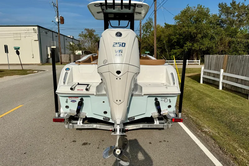 Slide: The Image of Rear view of 2026 Sea Hunt Ultra 235 SE boat on trailer, parked on roadside. - 3