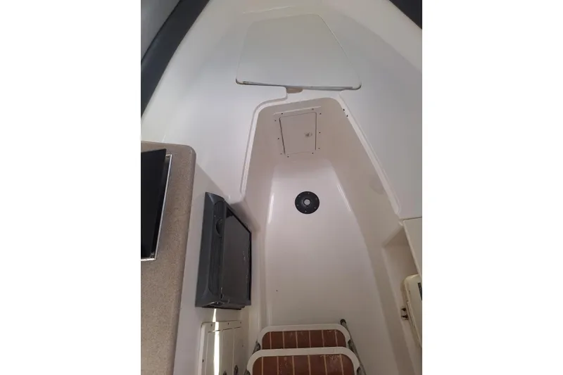 Slide: The Image of 2006 Century 2400 Walk-Around boat interior with steering wheel and cabin entrance. - 11