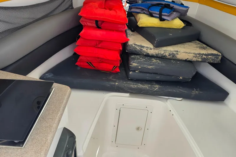 Slide: The Image of Interior of 2006 Century 2400 Walk-Around boat with life jackets and cushions. - 19