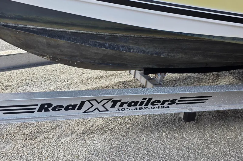 Slide: The Image of 2006 Century 2400 Walkaround boat on trailer under sunny sky. - 3