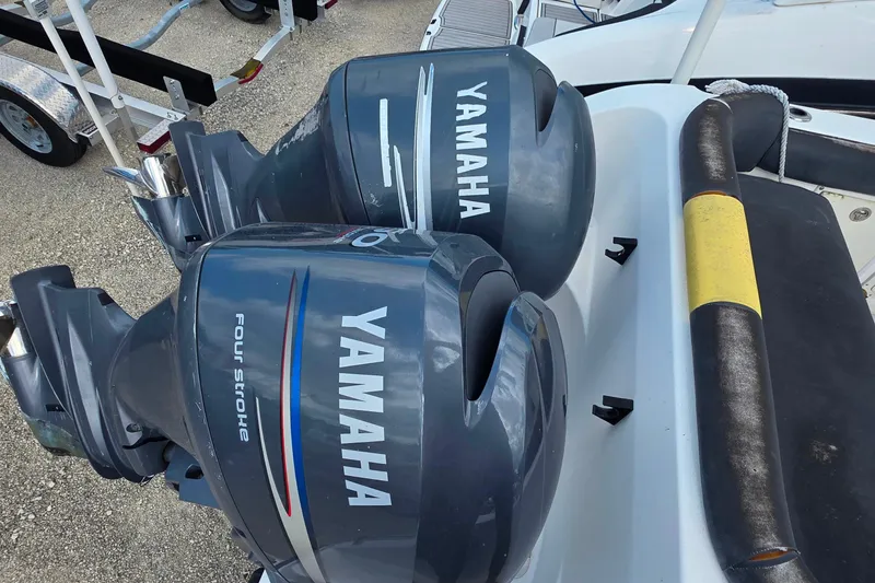 Slide: The Image of Twin Yamaha four-stroke outboard motors on a 2006 Century 2400 Walkaround boat. - 6