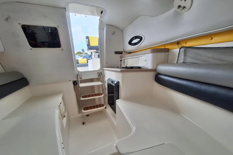 Slide: The Image of Century 2400 Walk-Around 2006 boat interior with yellow and black seating. - 8