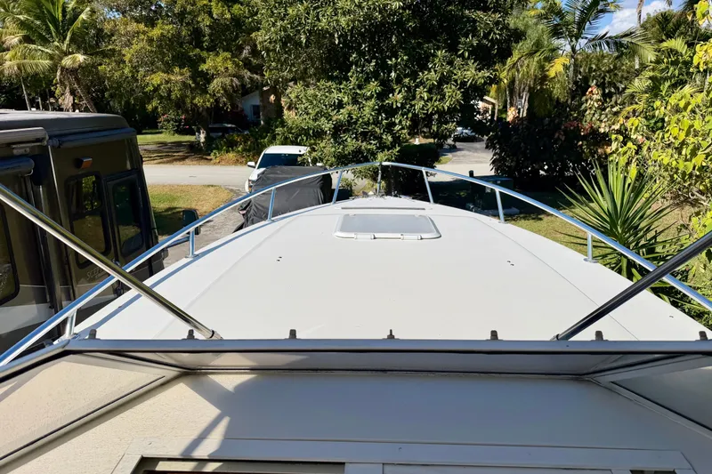 Slide: The Image of Boat dashboard with Garmin GPS, Suzuki displays, and communication equipment on a 2002 Contender 35 Side Console. - 10