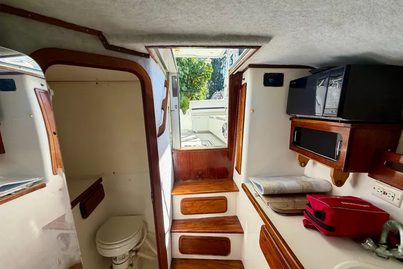 Slide: The Image of 2002 Contender 35 Side Console boat interior with seating and steering console. - 11