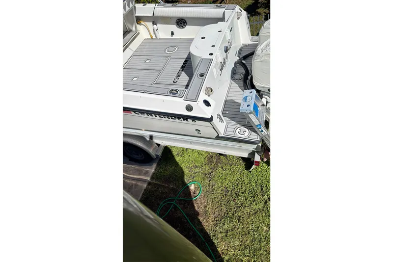 Slide: The Image of Interior of 2002 Contender 35 Side Console boat with seating, sink, and storage. - 15