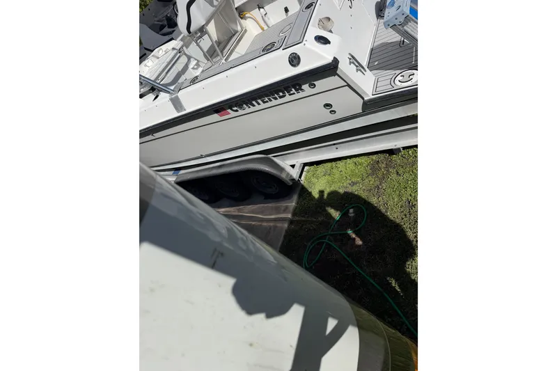 Slide: The Image of Interior of 2002 Contender 35 Side Console boat with white seating and compact amenities. - 16