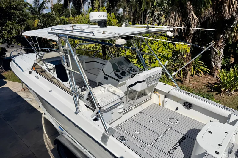 Slide: The Image of 1996 Contender 35 Side Console boat docked on a sunny day with cloudy sky. - 2