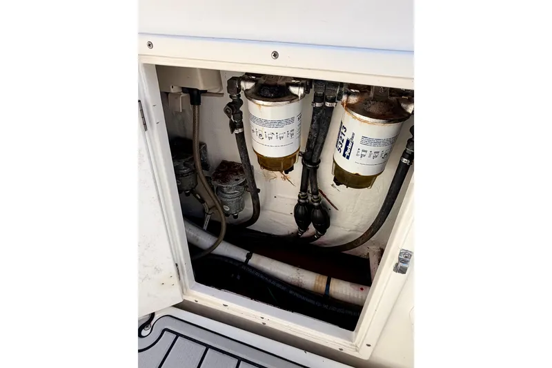 Slide: The Image of 2002 Contender 35 Side Console boat on trailer, surrounded by lush greenery. - 20