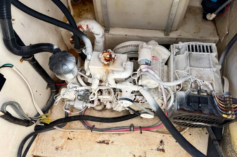 Slide: The Image of Engine compartment of a 2002 Contender 35 Side Console boat, showing mechanical components. - 26