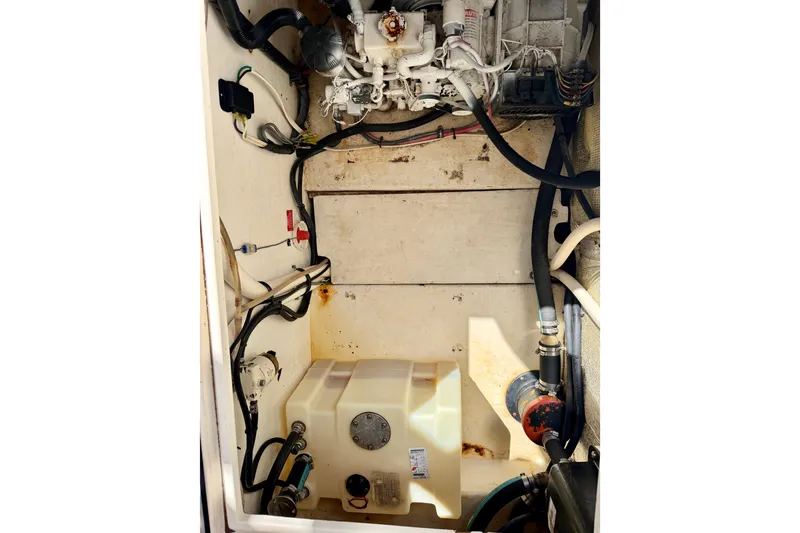 Slide: The Image of Engine compartment of a 2002 Contender 35 Side Console boat, showing various components and wiring. - 27