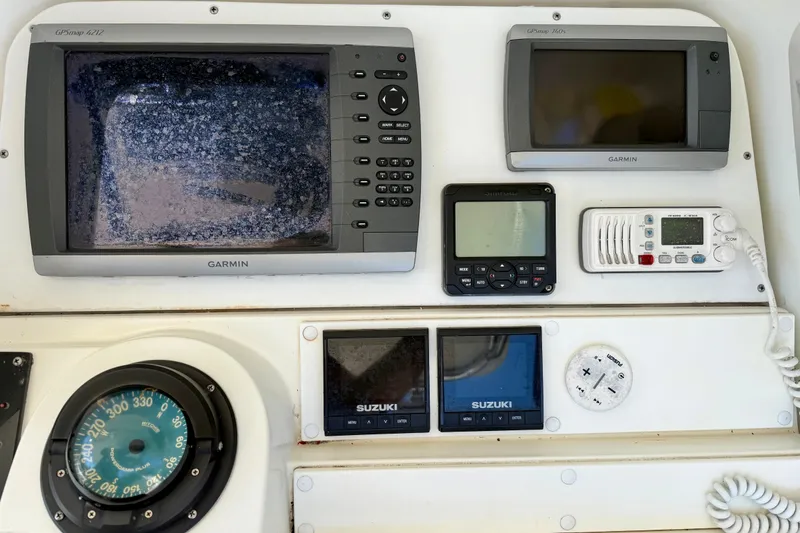 Slide: The Image of 2002 Contender 35 Side Console boat helm with steering wheel and navigation equipment. - 8