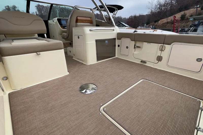 Slide: The Image of 2026 Chris-Craft Calypso 28 boat interior with beige seating and carpeted flooring. - 11