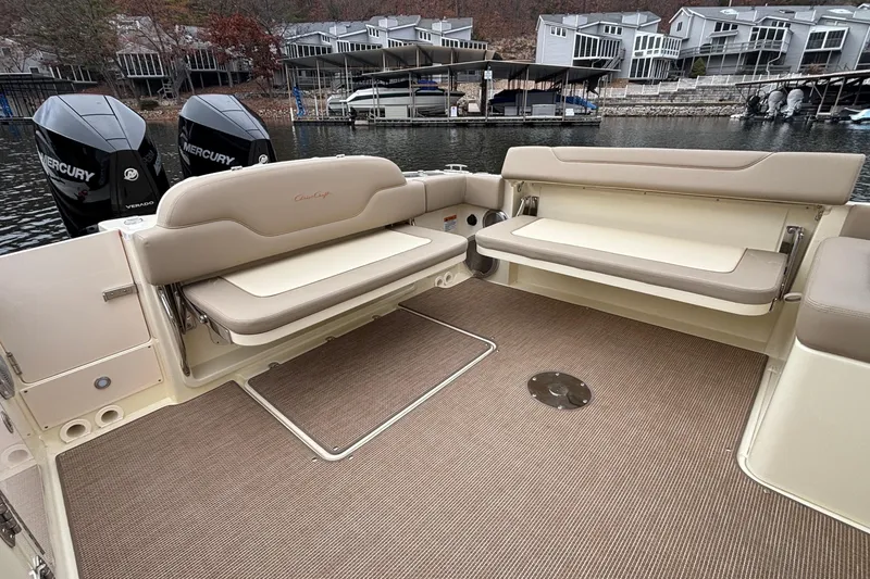 Slide: The Image of 2026 Chris-Craft Calypso 28 boat interior with beige seating and twin Mercury engines. - 14