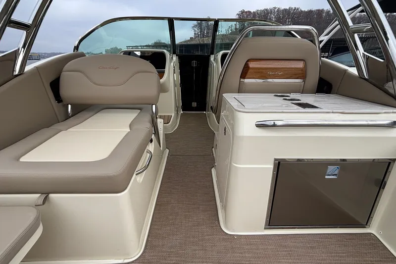 Slide: The Image of 2026 Chris-Craft Calypso 28 interior with beige seating and modern amenities. - 15
