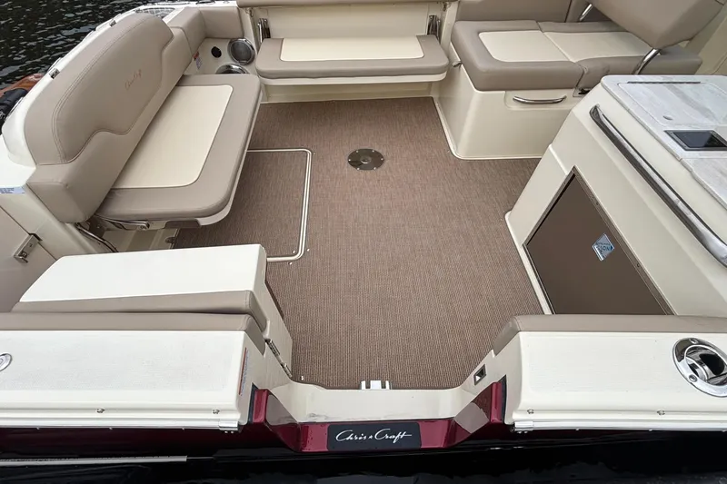 Slide: The Image of Luxurious interior of 2026 Chris-Craft Calypso 28 boat with beige seating and carpet. - 16