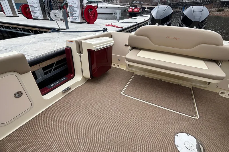 Slide: The Image of 2026 Chris-Craft Calypso 28 boat interior with beige seating and dock view. - 17