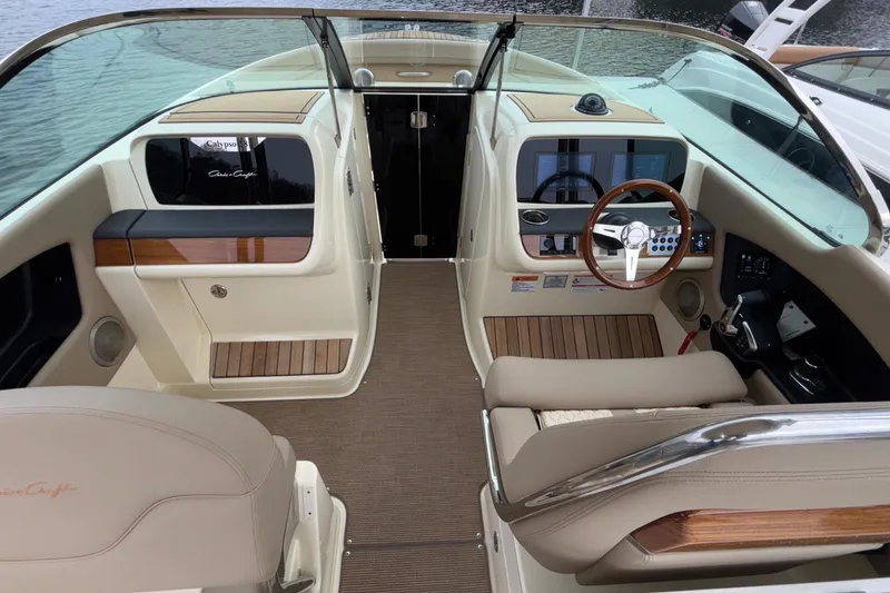 Slide: The Image of 2026 Chris-Craft Calypso 28 boat interior with modern dashboard and steering wheel. - 23