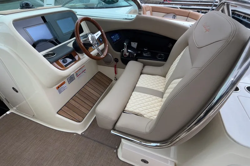 Slide: The Image of 2026 Chris-Craft Calypso 28 helm with luxurious seating and modern dashboard controls. - 26