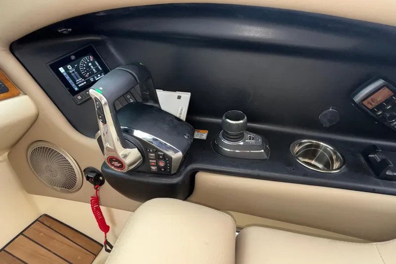 Slide: The Image of 2026 Chris-Craft Calypso 28 boat dashboard with controls and display panel. - 28