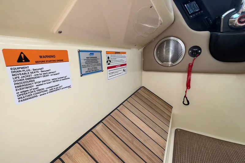 Slide: The Image of 2026 Chris-Craft Calypso 28 interior with safety warnings and speaker detail. - 29