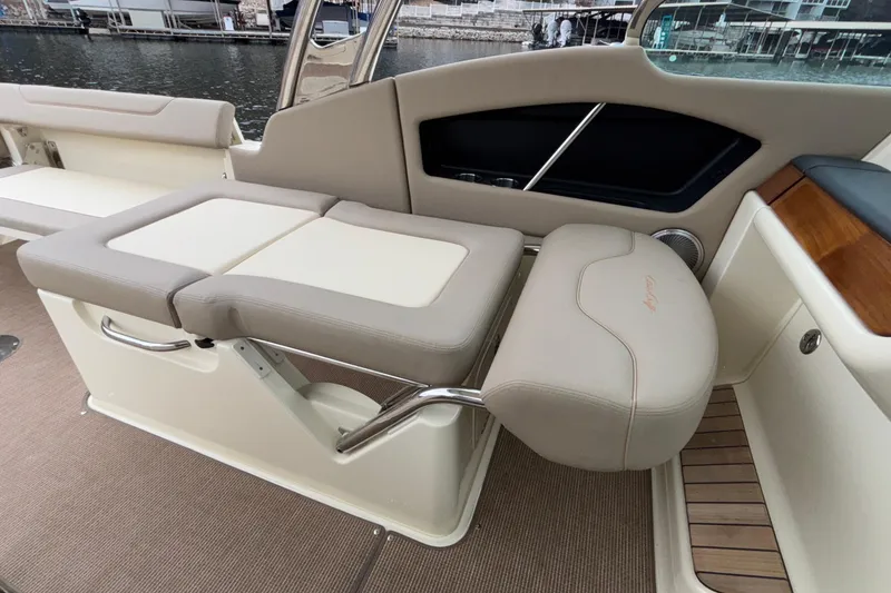 Slide: The Image of 2026 Chris-Craft Calypso 28 interior seating with beige upholstery and elegant design. - 34
