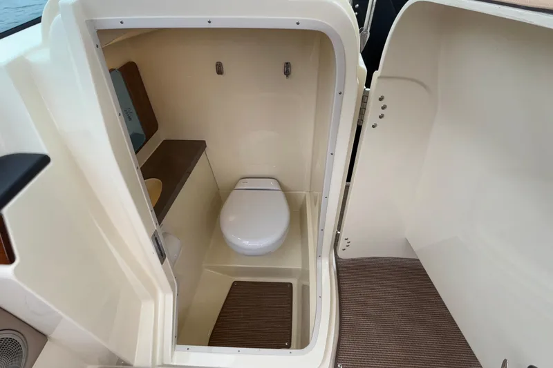 Slide: The Image of 2026 Chris-Craft Calypso 28 boat interior bathroom with toilet and compact design. - 39