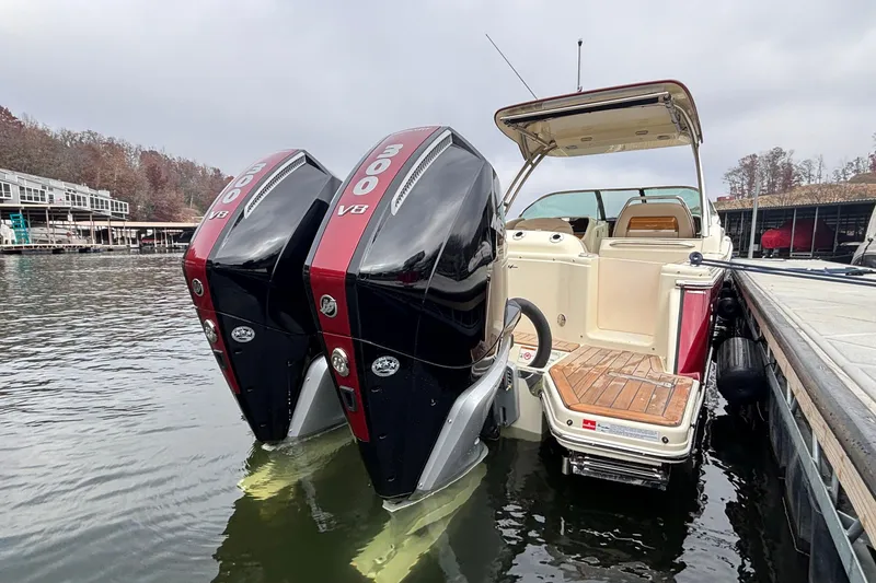 Slide: The Image of 2026 Chris-Craft Calypso 28 with dual 300 V8 engines docked on a calm lake. - 4