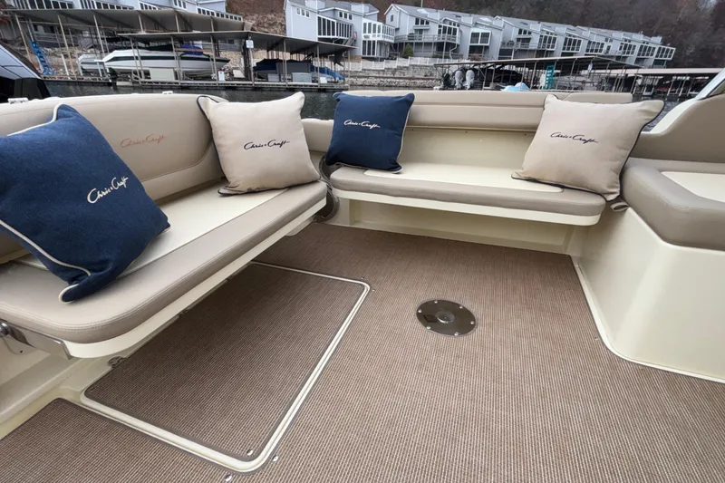 Slide: The Image of 2026 Chris-Craft Calypso 28 boat interior with cushioned seating and branded pillows. - 41