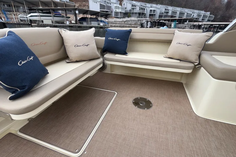 Slide: The Image of Interior seating of 2026 Chris-Craft Calypso 28 with branded cushions, dockside view. - 42