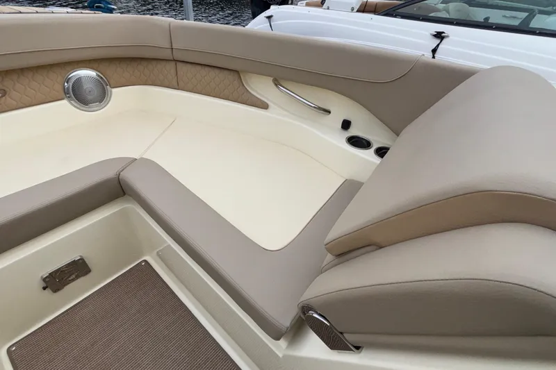 Slide: The Image of Luxurious interior of 2026 Chris-Craft Calypso 28 boat with beige seating and speaker. - 46