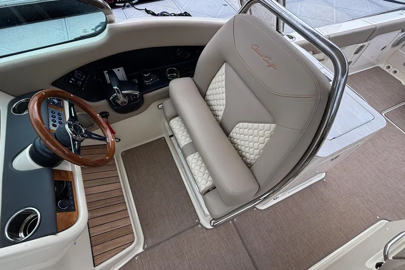 Slide: The Image of 2026 Chris-Craft Calypso 28 helm with luxurious seating and wooden steering wheel. - 58
