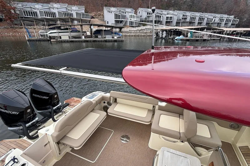 Slide: The Image of 2026 Chris-Craft Calypso 28 boat with Mercury engines docked near waterfront homes. - 61