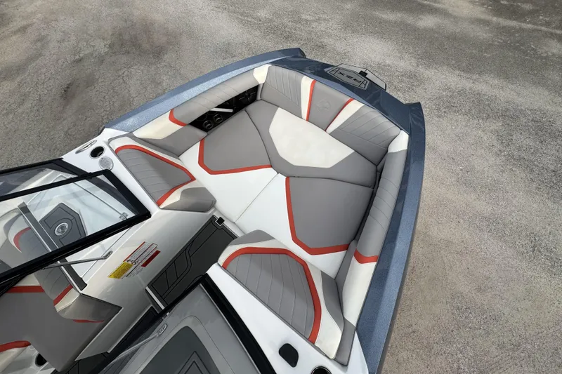 Slide: The Image of 2021 Tigé 23RZX boat interior with gray and red seating, viewed from above. - 10