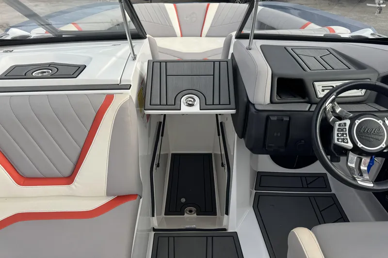 Slide: The Image of 2021 Tigé 23RZX boat interior with modern dashboard and stylish seating. - 11