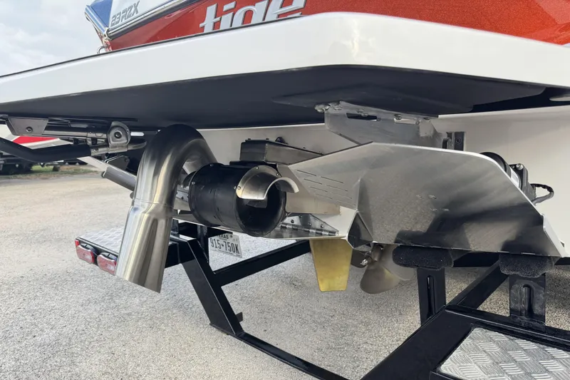 Slide: The Image of 2021 Tigé 23RZX boat stern with exhaust and propeller details. - 15