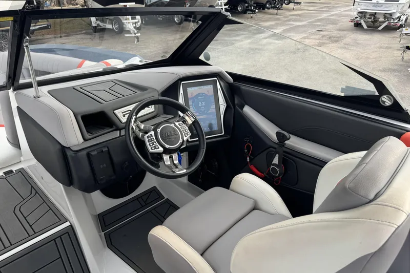 Slide: The Image of 2021 Tigé 23RZX boat interior with modern steering and touchscreen display. - 7