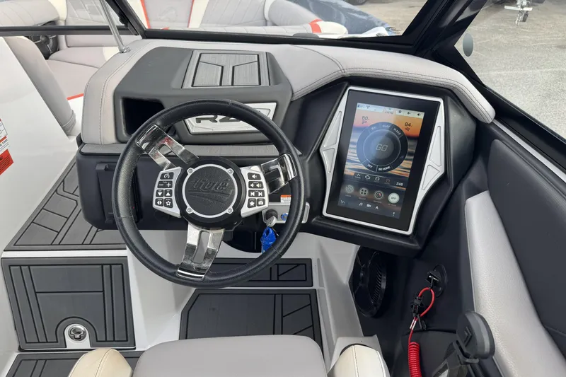 Slide: The Image of 2021 Tigé 23RZX boat dashboard with touchscreen display and steering wheel. - 9
