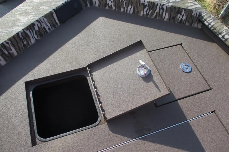 Slide: The Image of 2026 Avid 18 Rogue CC boat deck with open storage compartments. - 10