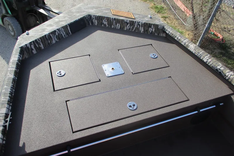 Slide: The Image of 2026 Avid 18 Rogue CC boat deck with storage compartments and camouflage trim. - 12