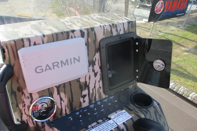 Slide: The Image of Control panel of Avid 18 Rogue CC 2026 boat with Garmin device and Yamaha banner. - 13