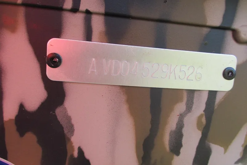 Slide: The Image of Serial number plate on 2026 Avid 18 Rogue CC with camouflage background. - 14