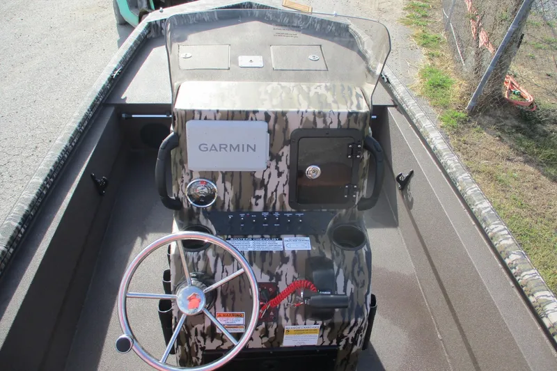 Slide: The Image of 2026 Avid 18 Rogue CC boat console with Garmin navigation system and camouflage design. - 16