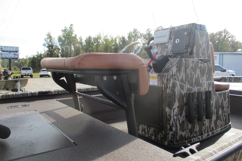 Slide: The Image of 2026 Avid 18 Rogue CC boat with camo console and brown seating, featuring Garmin equipment. - 4