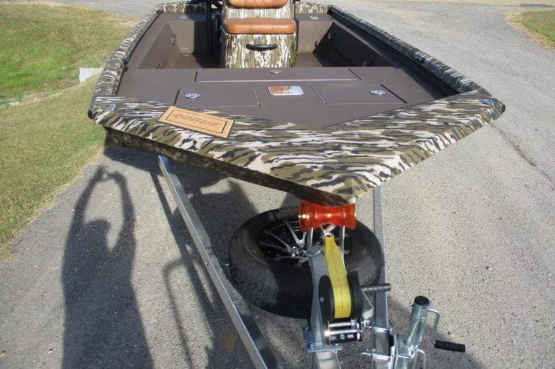 Slide: The Image of 2026 Avid 18 Rogue CC boat with camouflage design on a trailer. - 6