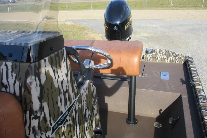 Slide: The Image of Avid 18 Rogue CC 2026 boat interior with camouflage design and steering wheel. - 7