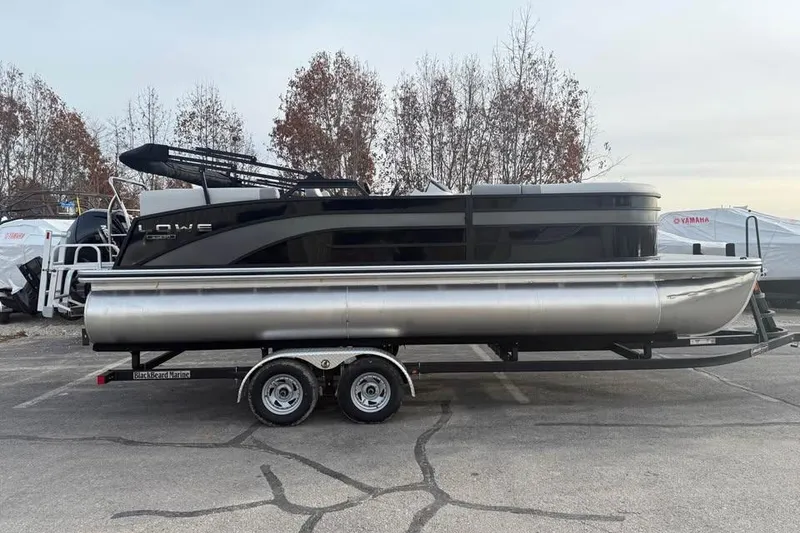 The Image of 2026 Lowe SS 230 WV pontoon boat on trailer in parking lot. - 0