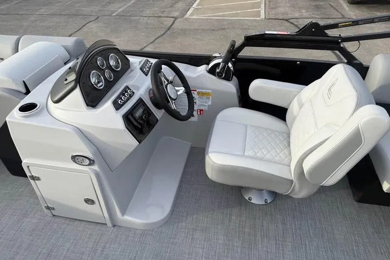 Slide: The Image of 2026 Lowe SS 230 WV boat interior with modern dashboard and plush seating. - 11